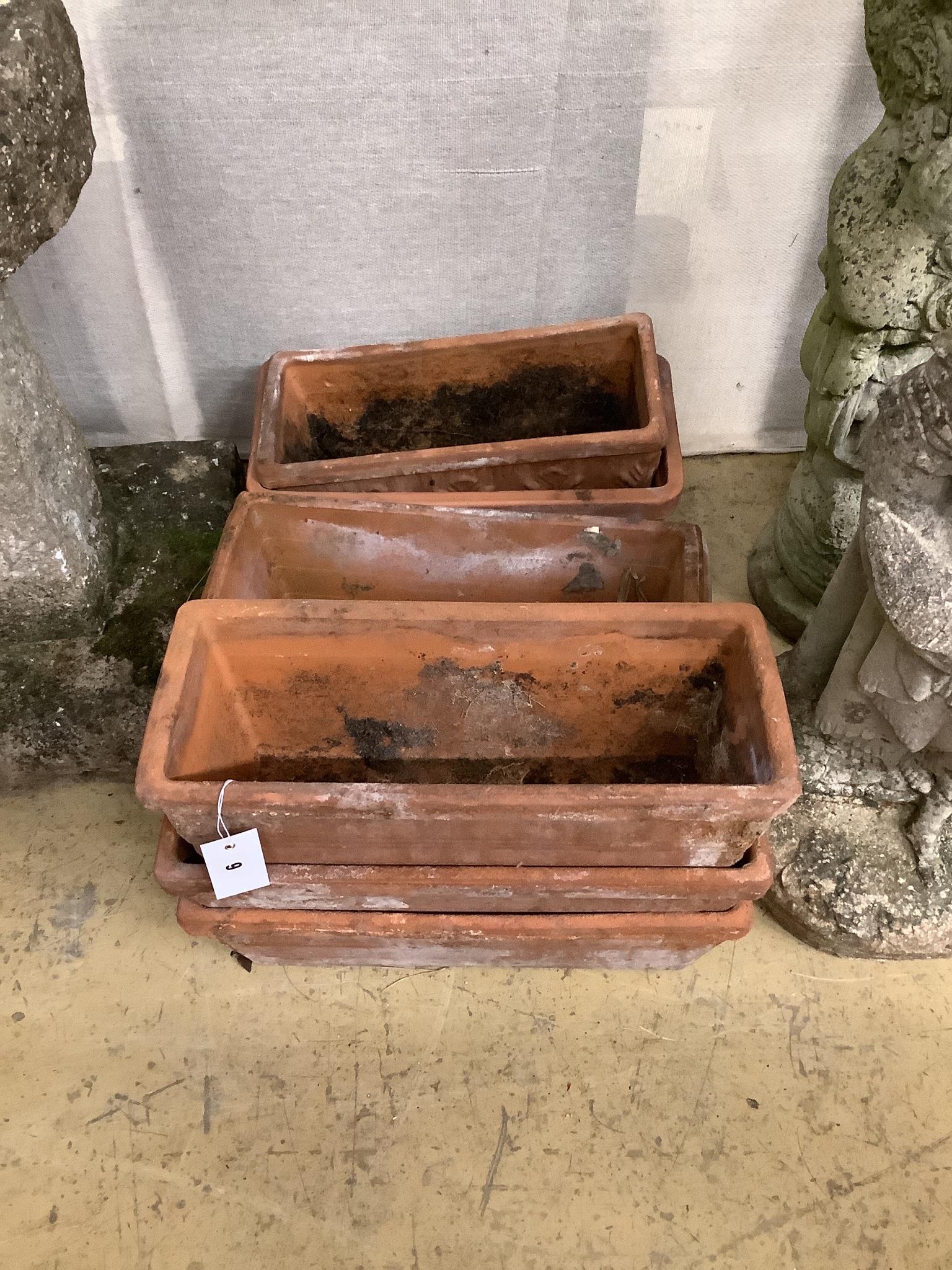 A set of three terracotta garden troughs and four similar troughs, approx. 40cm, wide
